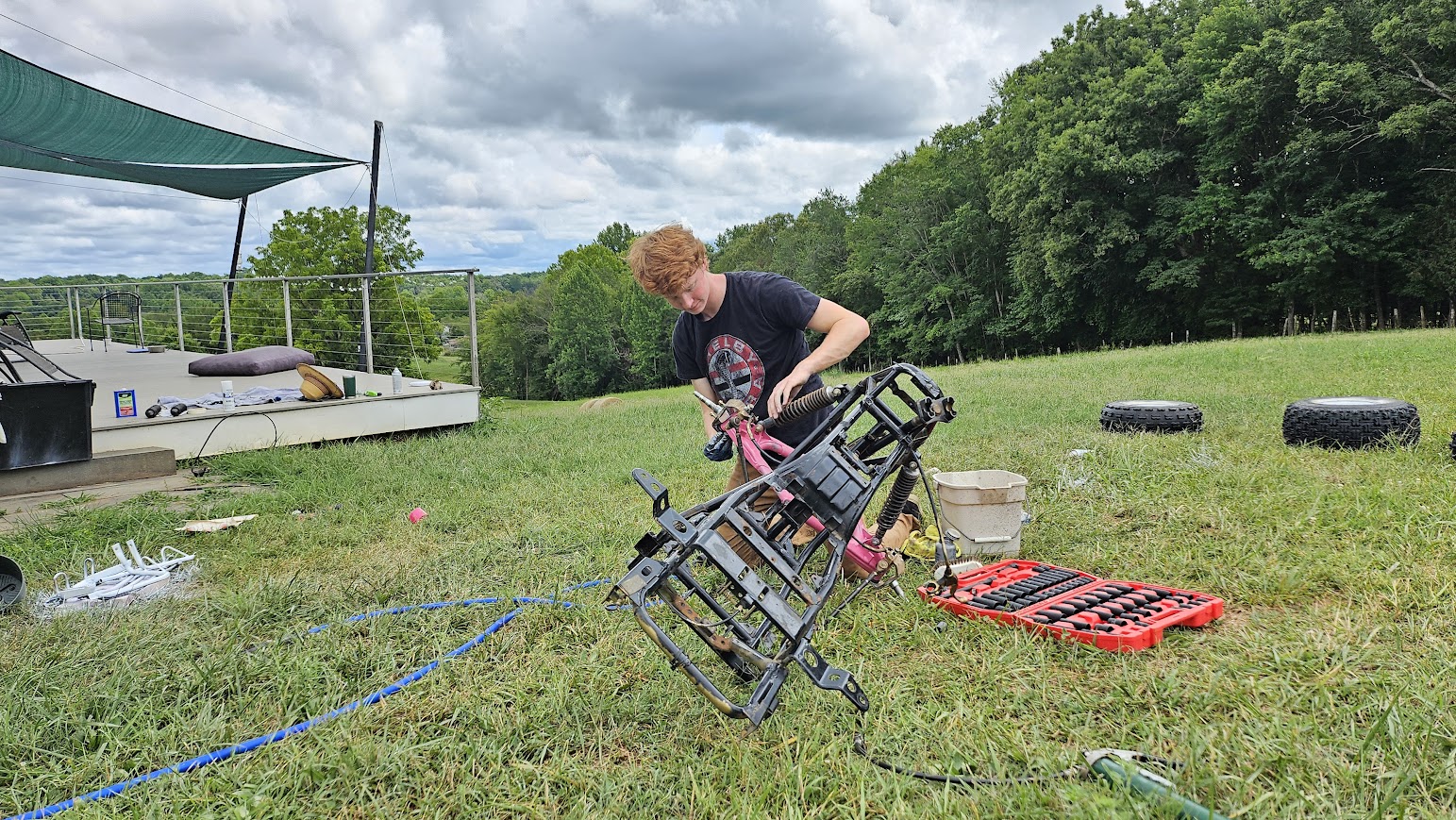 Me working on the stripped-down frame of an ATV
