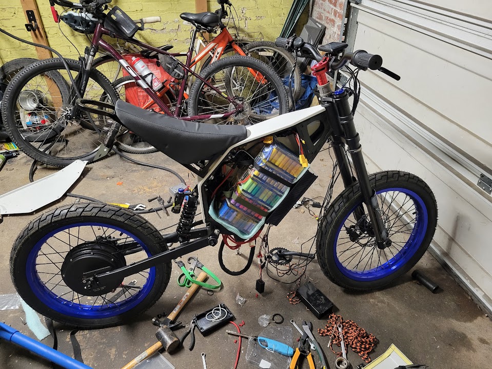 The partially assembled bike frame with wheels and suspension